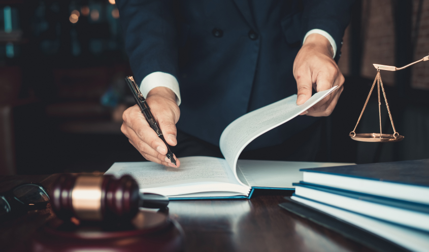 A business lawyer reviews a legal document.