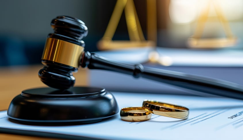 A gavel and wedding rings represent postnuptial agreements.