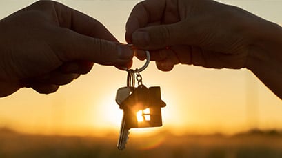 A person handing over a set of car keys