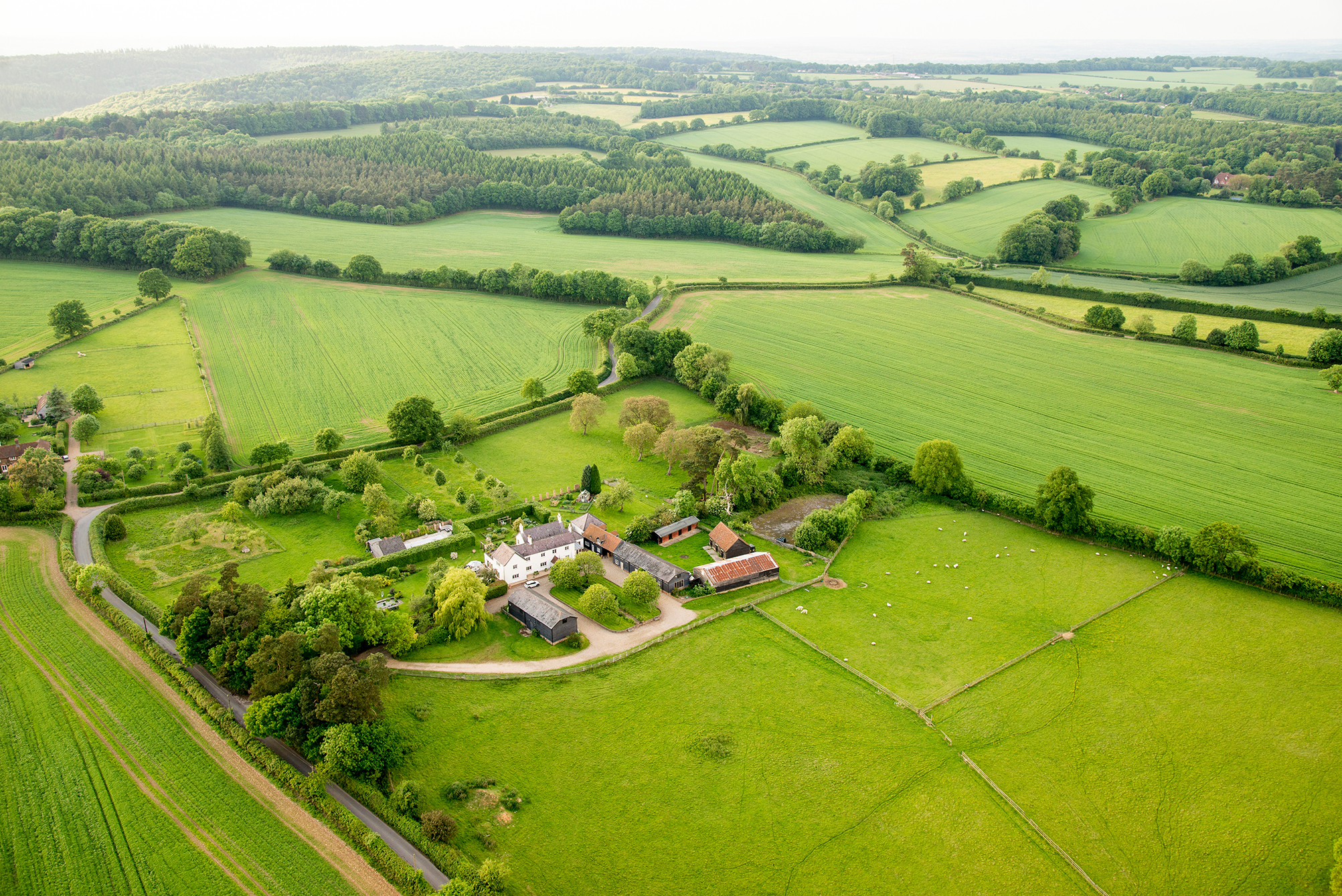 Aerial view of small buildings surrounded by large open land