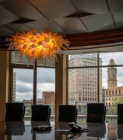 Large board room with city in the background Large board room with city in the background