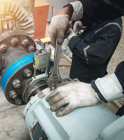 Man using wrench on equipment