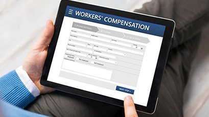 Person filling out a workers comp form on tablet