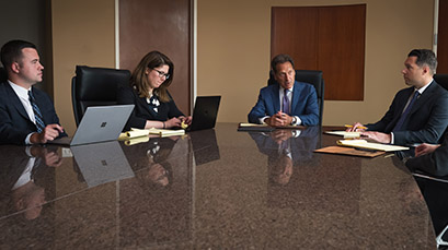 The Plakas Mannos commercial litigation team in a meeting